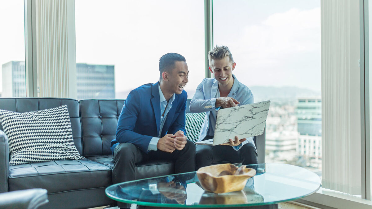 Two men with a laptop