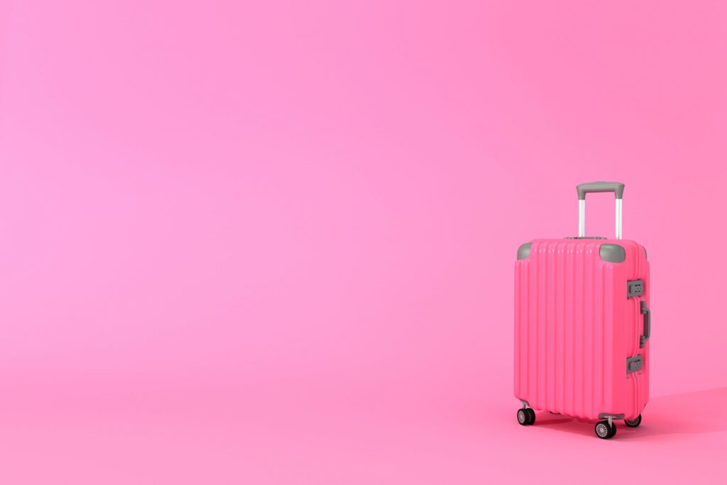 pink suitcase hardshell bright pink background
